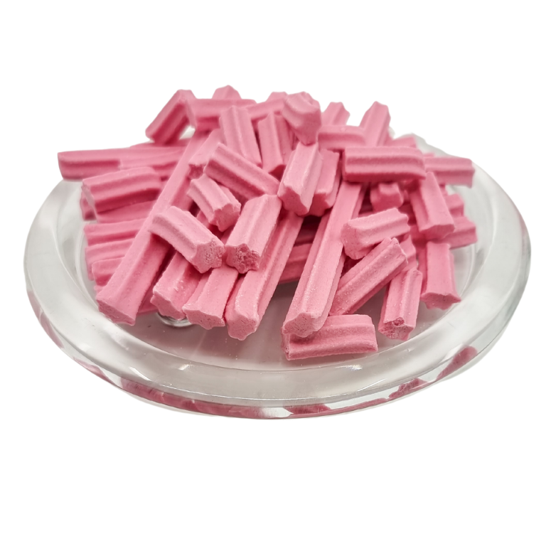 Musk stick lollies on a clear plate